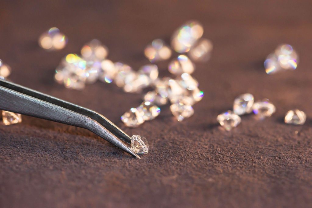 Diamond with tweezers and magnifier.