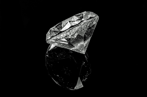 Single diamond on black background.